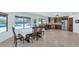 Open floor plan leading to the kitchen with tile flooring, stainless steel appliances, and natural light at 3611 E Ahwatukee Dr, Phoenix, AZ 85044
