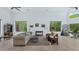 Bright living room with high ceilings, neutral color palette, and large windows offering outdoor views at 3611 E Ahwatukee Dr, Phoenix, AZ 85044