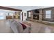 Living room featuring a stone fireplace, wood accents, tile flooring, and open kitchen access at 3611 E Ahwatukee Dr, Phoenix, AZ 85044