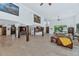 Expansive open-plan living area with wooden pillars, staircase, neutral tones and large windows at 3611 E Ahwatukee Dr, Phoenix, AZ 85044