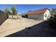 The home features a large backyard with desert landscaping, providing a private outdoor space at 4008 E Knox Rd, Phoenix, AZ 85044
