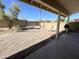 View of a backyard with desert landscaping, a patio, and a white lounge chair at 4008 E Knox Rd, Phoenix, AZ 85044