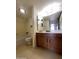 Bathroom featuring a vanity with dark wood cabinets, a mirror and a combined bathtub and shower at 4008 E Knox Rd, Phoenix, AZ 85044