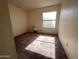 This cozy bedroom has a large window and wall-to-wall carpeting at 4008 E Knox Rd, Phoenix, AZ 85044
