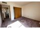 Bedroom with closet doors and transition to another room at 4008 E Knox Rd, Phoenix, AZ 85044