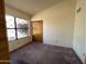 Well-lit bedroom features a large window with diamond pattern and closet with sliding doors at 4008 E Knox Rd, Phoenix, AZ 85044
