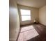 Empty bedroom with a large window and lamp. Features wall-to-wall carpeting at 4008 E Knox Rd, Phoenix, AZ 85044