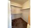 Walk-in closet featuring carpeted floors and white shelving on three sides at 4008 E Knox Rd, Phoenix, AZ 85044