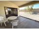 Covered patio with an outdoor table and chairs, overlooking the spacious backyard at 4008 E Knox Rd, Phoenix, AZ 85044
