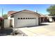Home featuring a two-car garage with decorative trim and a red tile roof at 4008 E Knox Rd, Phoenix, AZ 85044