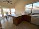 Sunlit eat-in kitchen with an island, plenty of counter space, and a sink beneath a bright window at 4008 E Knox Rd, Phoenix, AZ 85044