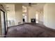 Open-concept living area featuring a fireplace, carpeted flooring, and backyard access at 4008 E Knox Rd, Phoenix, AZ 85044