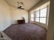 Carpeted living room with large windows, a ceiling fan, and classic style at 4008 E Knox Rd, Phoenix, AZ 85044