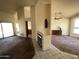 Open-concept living area with a fireplace and tiled flooring, seamlessly connecting to the adjacent dining area and backyard at 4008 E Knox Rd, Phoenix, AZ 85044