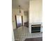 Cozy living room with tile flooring, brick fireplace, and classic lighting fixture at 4008 E Knox Rd, Phoenix, AZ 85044