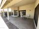 View of a covered patio with a table, chairs, and a grill, perfect for outdoor dining at 4008 E Knox Rd, Phoenix, AZ 85044