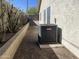 Exterior side yard featuring an AC unit on a gravel base and privacy wall at 4008 E Knox Rd, Phoenix, AZ 85044