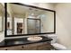 Bathroom with a light pink sink, large vanity mirror, tile shower, and toilet at 4015 N 78Th St # 135, Scottsdale, AZ 85251