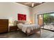 Bright bedroom featuring a ceiling fan and a sliding glass door leading to outdoor patio seating at 4015 N 78Th St # 135, Scottsdale, AZ 85251