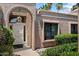 Inviting arched entryway with a decorative white security door and a glimpse of lush landscaping at 4015 N 78Th St # 135, Scottsdale, AZ 85251