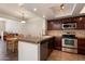 Open kitchen with granite countertops, stainless steel appliances, and an adjacent dining area at 4015 N 78Th St # 135, Scottsdale, AZ 85251