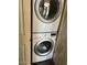 Stacked white washer and dryer appliances enhance efficiency of a modern laundry room at 4015 N 78Th St # 135, Scottsdale, AZ 85251