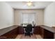 Home office with wrap around desk and dark brown cabinets with natural light and neutral colors at 4015 N 78Th St # 135, Scottsdale, AZ 85251