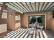 Covered patio with a wrought iron table and chairs and an outdoor lighting fixture at 4015 N 78Th St # 135, Scottsdale, AZ 85251