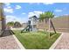 Backyard features a playset with a swing, slide and rock landscaping, a perfect space for to enjoy at 42726 N Livingstone Way, Anthem, AZ 85086