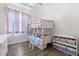 Bedroom with bunk beds, storage, and rainbow themed decorations at 42726 N Livingstone Way, Anthem, AZ 85086