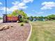 Entrance to the Anthem Community Park, featuring a stone sign and view of a lake with a waterfall at 42726 N Livingstone Way, Anthem, AZ 85086