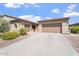 Charming home featuring a three-car garage, desert landscaping, and a welcoming red front door at 42726 N Livingstone Way, Anthem, AZ 85086