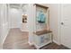 Hallway with wood floors and a built in coat rack and cabinets, offering storage and organization at 42726 N Livingstone Way, Anthem, AZ 85086
