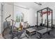 Home gym with a window, a fan, weights, gym equipment, and rubber flooring providing a great space to exercise at 42726 N Livingstone Way, Anthem, AZ 85086