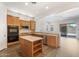 Well-equipped kitchen featuring stainless steel appliances, wooden cabinetry, and center island at 42726 N Livingstone Way, Anthem, AZ 85086