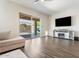 Cozy living room features a modern entertainment center with fireplace and access to the backyard at 42726 N Livingstone Way, Anthem, AZ 85086
