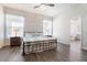 Serene main bedroom with wood floors, decorative lamps, and ensuite bathroom at 42726 N Livingstone Way, Anthem, AZ 85086