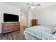 Spacious main bedroom with wooden furniture, walk-in closet and a ceiling fan at 42726 N Livingstone Way, Anthem, AZ 85086