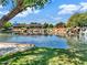 Serene pond featuring tranquil water features, lush landscaping, and charming architecture at 42726 N Livingstone Way, Anthem, AZ 85086