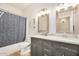 Bathroom featuring double vanity with granite countertop and shower with curtain at 4345 E Annette Dr, Phoenix, AZ 85032