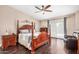 Spacious primary bedroom featuring a ceiling fan, hardwood floors and backyard access at 4345 E Annette Dr, Phoenix, AZ 85032