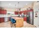 Well-appointed kitchen features stainless steel appliances, brick accents, and a center island at 4345 E Annette Dr, Phoenix, AZ 85032