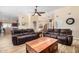 Spacious living room with vaulted ceilings, tile floors, and comfortable leather sofas at 4345 E Annette Dr, Phoenix, AZ 85032
