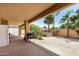 Spacious covered patio featuring a grill, refrigerator, and views of the lush backyard at 4345 E Annette Dr, Phoenix, AZ 85032