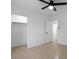 Neutral bedroom with tile floors, ceiling fan, closet and interior door at 4400 N 20Th St, Phoenix, AZ 85016