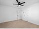 This spacious bedroom features clean white walls, tile floors, and a ceiling fan at 4400 N 20Th St, Phoenix, AZ 85016