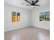 Bright bedroom with neutral paint, fan, and tile floors illuminated by natural light at 4400 N 20Th St, Phoenix, AZ 85016