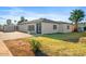 Charming single-story home features a well-maintained front yard, mature palm trees, and a neutral color palette at 4400 N 20Th St, Phoenix, AZ 85016