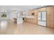 Modern kitchen with a large island, stainless steel appliances, wood cabinets, and stylish lighting fixtures at 4400 N 20Th St, Phoenix, AZ 85016