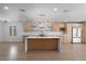 Modern kitchen boasting stainless steel appliances, sleek wood cabinets, and a spacious island with a marble countertop at 4400 N 20Th St, Phoenix, AZ 85016
